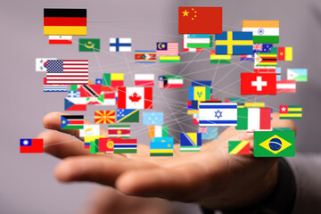 Hand holding interconnected flags, symbolizing global collaboration and international relations.