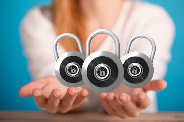 Image of three padlocks held in hands, symbolizing data protection and online security.