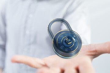 Image of a digital combination lock hovering above an open hand, symbolizing data security and...