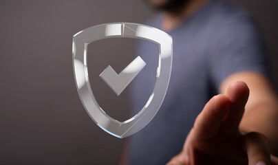 Hand reaching for a digital shield, symbolizing data security and protection.
