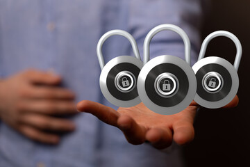 Image of three padlocks on an open hand, symbolizing data security and protection.