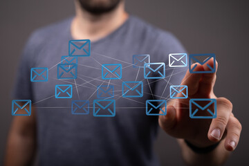 Man interacts with a digital network of emails, showcasing global communication and...