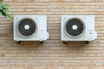 Installing air conditioning units with visible chaos on a brick wall during summer heat