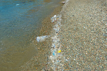 Plastic soup; large amount of small plastic pieces at the waterline, caused by erosion of larger pieces