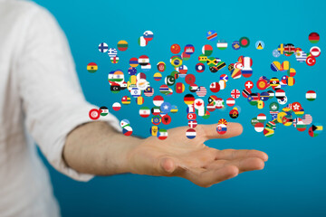 Diverse flags on an open hand, representing global connections and international collaboration.