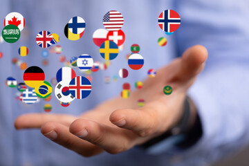 Image of a hand gently cradling various national flags, symbolizing global connections and...