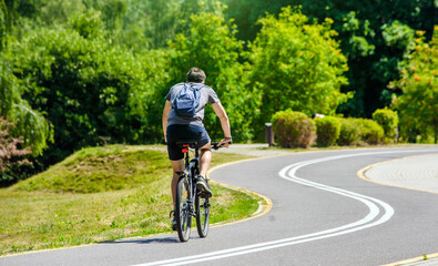 Fototapeta premium Cyclist ride on the bike path in the city Park 