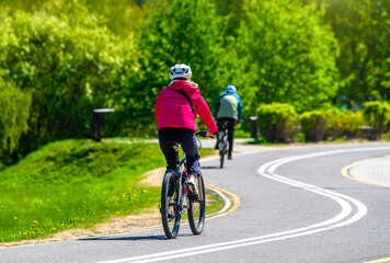 Cyclist ride on the bike path in the city Park
