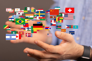 Image of hands holding a network of world flags, symbolizing global connections and international...