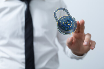 Image of a businessman interacting with a virtual padlock, symbolizing digital security and data...