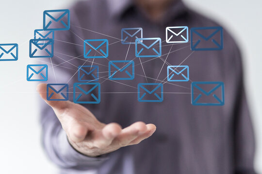 Hand holding network of email icons.  Digital communication, global network, internet concept.