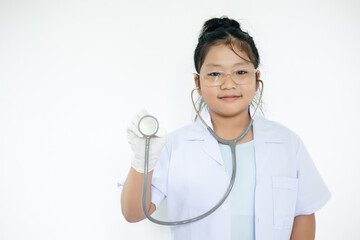 Girl in doctor outfit wearing stethoscope on isolated white background