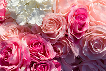 Close-up of soft pink and white artificial roses with delicate textures, ideal for romantic or...