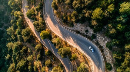 Fototapeta premium A winding road with trees in the background