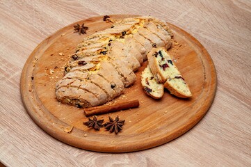 A top-down view of sliced biscotti with cranberries, star anise, and cinnamon.