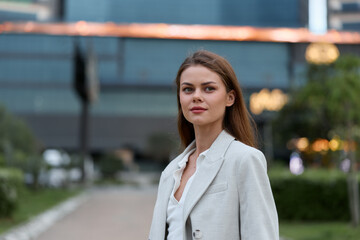 confident woman in white blazer portrait city background business style outdoor season spring...