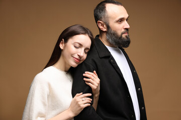 Cute daughter and father on brown background