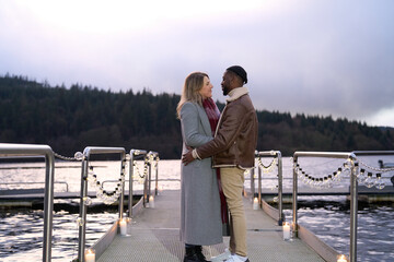 Couple embracing on decorated pier