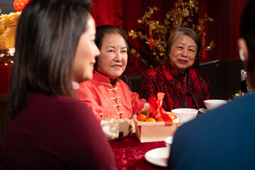 Smiling family celebrating Chinese New Year in restaurant