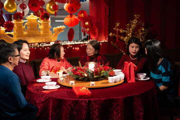 Smiling family celebrating Chinese New Year in restaurant