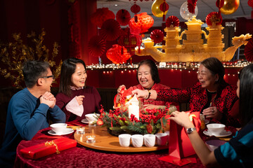 Smiling family celebrating Chinese New Year in restaurant