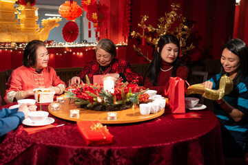 Smiling family celebrating Chinese New Year in restaurant