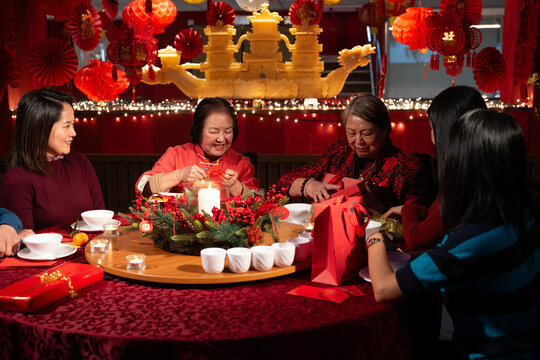 Smiling family celebrating Chinese New Year in restaurant