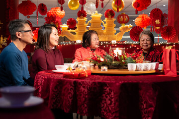Smiling family celebrating Chinese New Year in restaurant