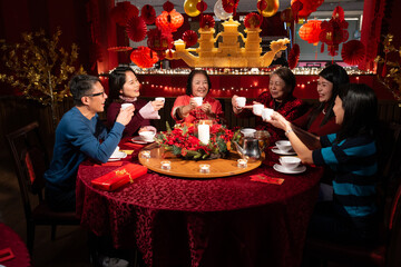 Smiling family toasting during Chinese New Year celebration in restaurant