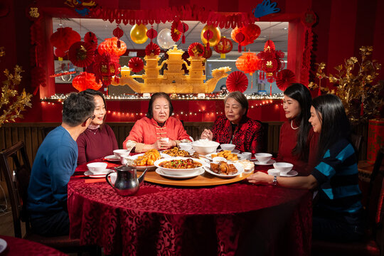 Smiling family enjoying Chinese New Year dinner in restaurant