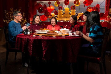 Smiling family enjoying Chinese New Year dinner in restaurant