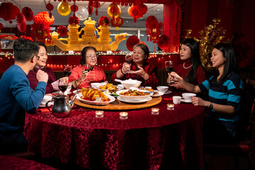 Smiling family enjoying Chinese New Year dinner in restaurant