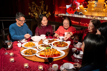 Smiling family enjoying Chinese New Year dinner in restaurant