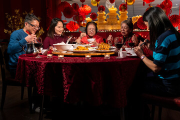 Family enjoying Chinese New Year dinner in restaurant