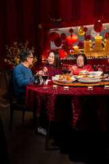 Family enjoying Chinese New Year dinner in restaurant