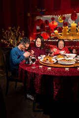 Family enjoying Chinese New Year dinner in restaurant