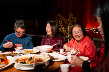 Family enjoying Chinese New Year dinner in restaurant