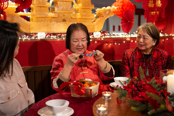 Smiling family celebrating Chinese New Year in restaurant