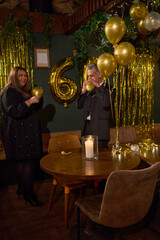 Elegant older man celebrating his 60th birthday at nightclub