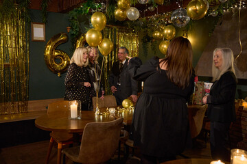 People celebrating 60th birthday at nightclub