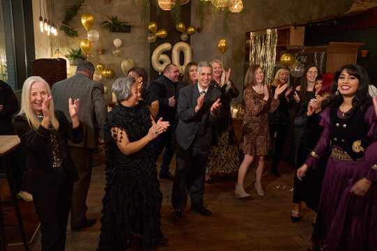 People attending dance show at 60th birthday party at nightclub