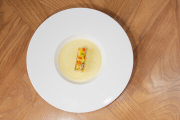 Fine Dining Cream Soup with Gourmet Garnish on White Plate
