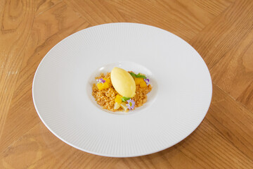 Mango Sorbet with Crumble and Edible Flowers on White Plate