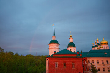 A building with a green roof and a rainbow on the roof