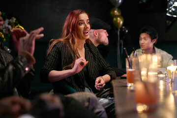 Group of friends meeting in nightclub to celebrate New Year's Eve