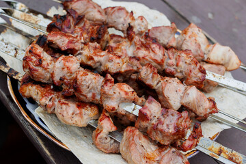 Top down close up of boneless, skinless chicken thighs being grilled.