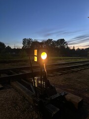 A yellow light is lit up on a train track