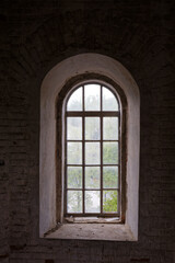 A window with a view of trees and a road