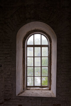 A window with a view of trees and a road