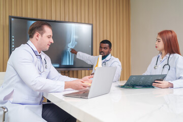 medical team discussing and review rare disease case to improve the practice guidelines,multiracial orthopedic doctors working in medical conference room